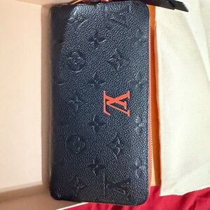 Louis Vuitton Zippy Wallet in black/red Monogram Empreinte leather.